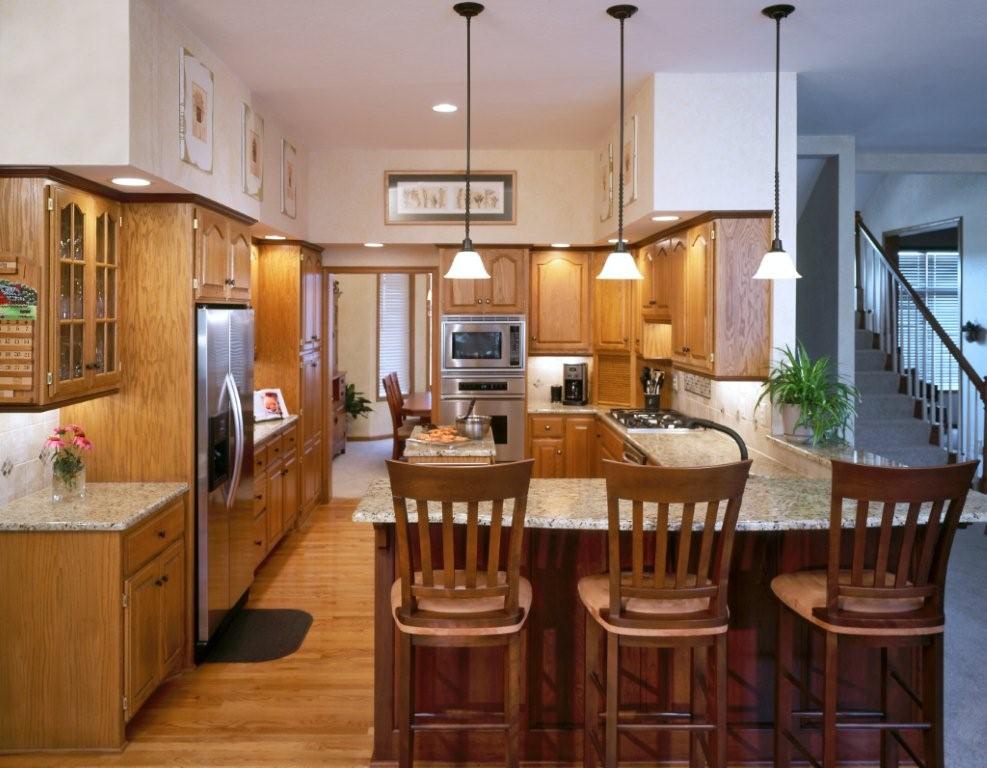 Kitchen with wood cabinets and raised chairs