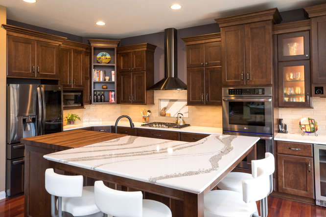 Kitchen with island counter and dark wood cabinets