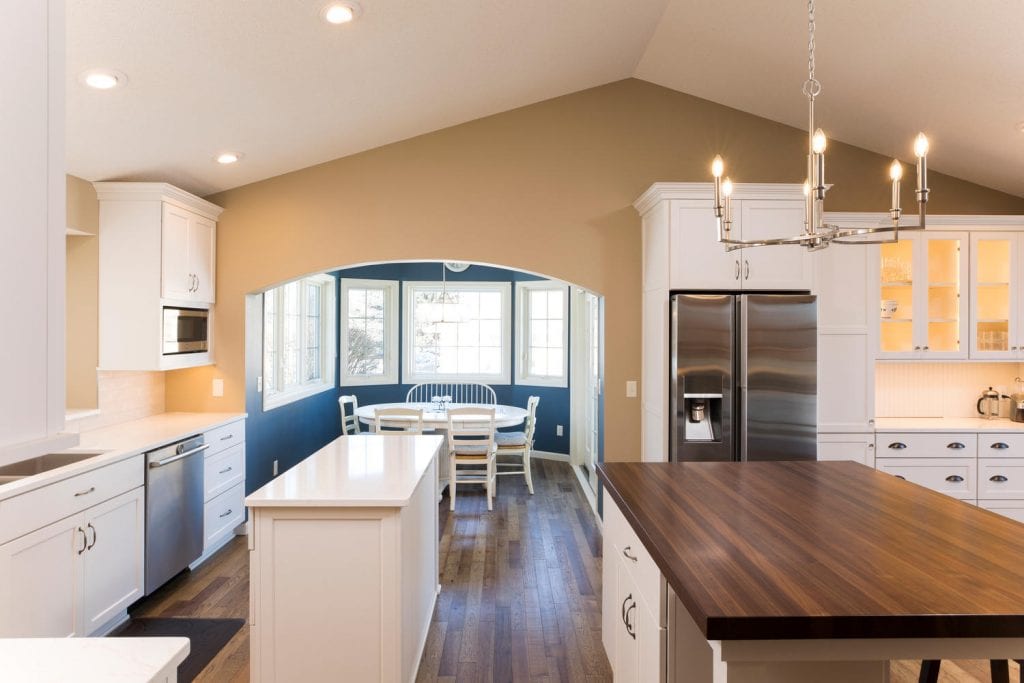 interior of a kitchen, showcasing a separate dining area behind an arch