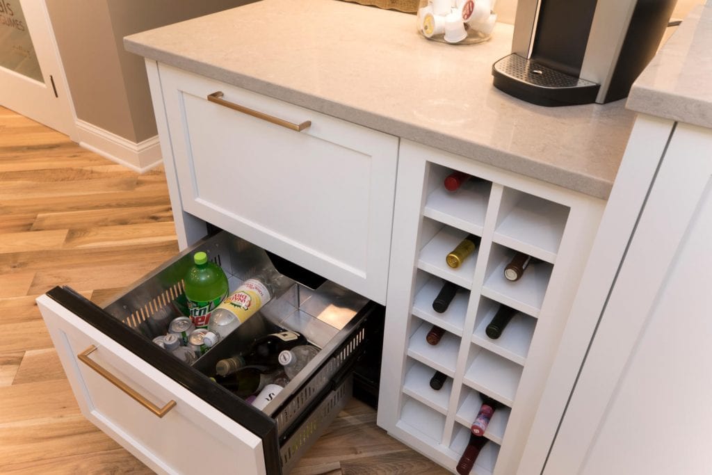 a kitchen cabinet opening to show compartmentalized storage