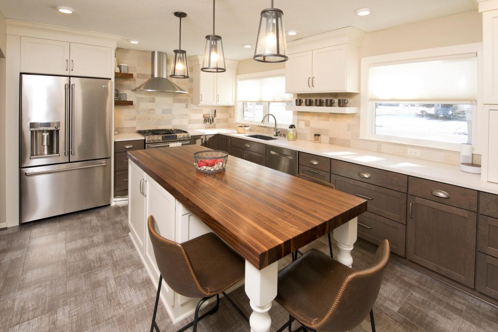 a kitchen with vinyl flooring and dark cabinets, with white countertops