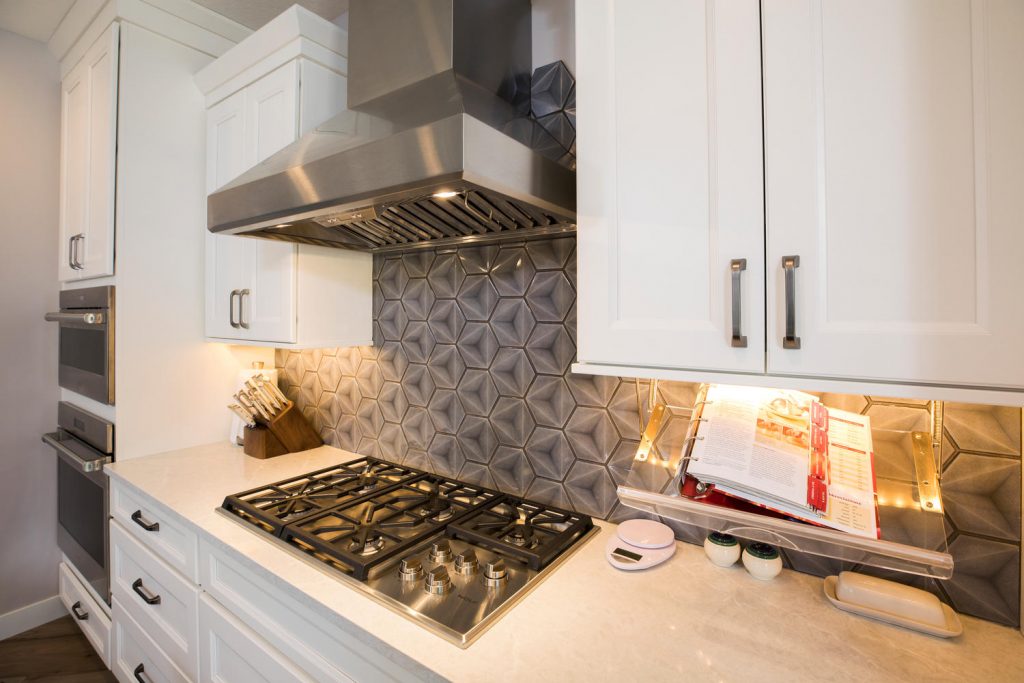 a backsplash above a stove. the design is hexagonal and modern